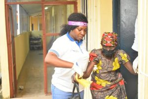 An elderly woman being brought in for medical attention at Oleh.