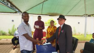 Chief. Njiokwuemeni (right) congratulates a recipient of the Ndudi Elumelu starter pack for young farmers.