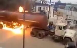 The fuel laden tanker in flames, yet being driven to a safer location by the gallant driver.